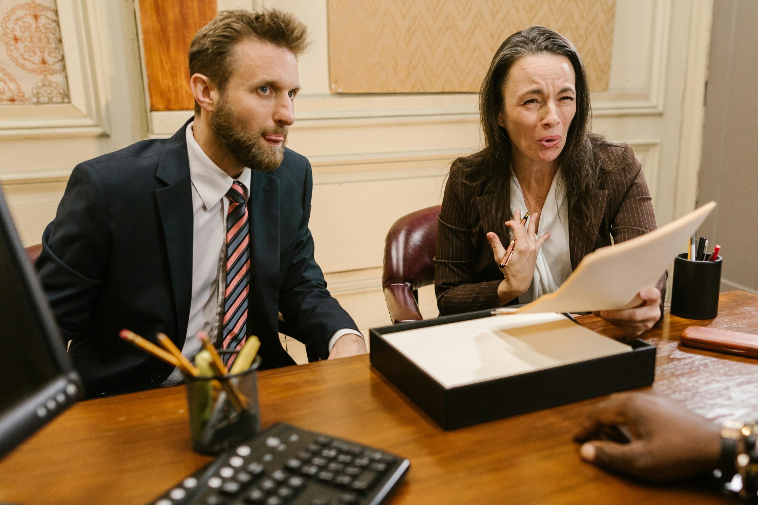 Lawyers discussing legal documents in a professional office setting.